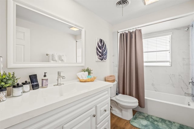 full bathroom with shower / bathtub combination with curtain, hardwood / wood-style floors, vanity, and toilet