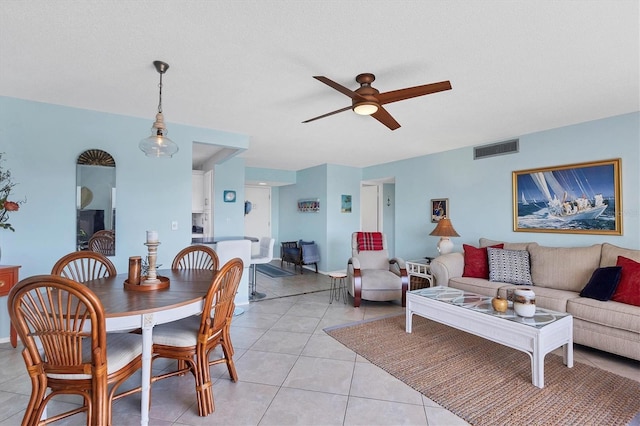 dining area with light tile patterned floors, a textured ceiling, and ceiling fan