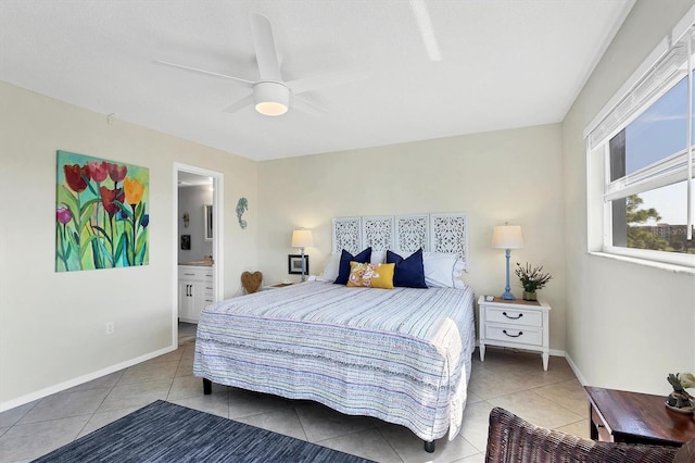 bedroom with tile patterned flooring, ensuite bathroom, and ceiling fan