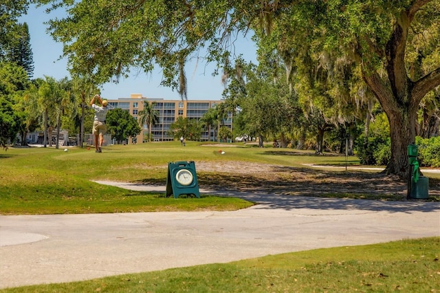 view of property's community with a lawn