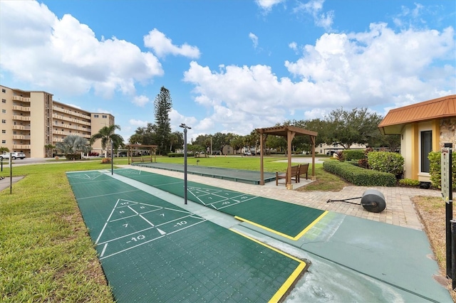 view of property's community with a pergola and a lawn