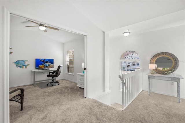 office area featuring ceiling fan, lofted ceiling, and light carpet