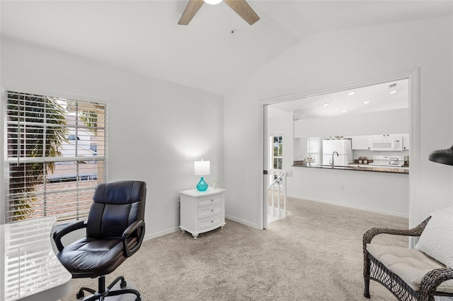 carpeted office featuring lofted ceiling and ceiling fan