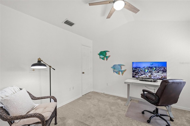 carpeted home office featuring lofted ceiling and ceiling fan