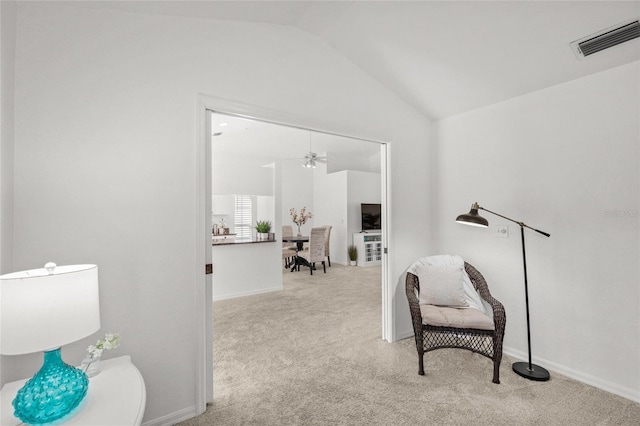 sitting room featuring lofted ceiling and light colored carpet