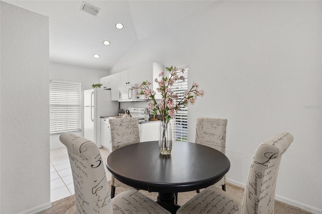 dining space featuring lofted ceiling