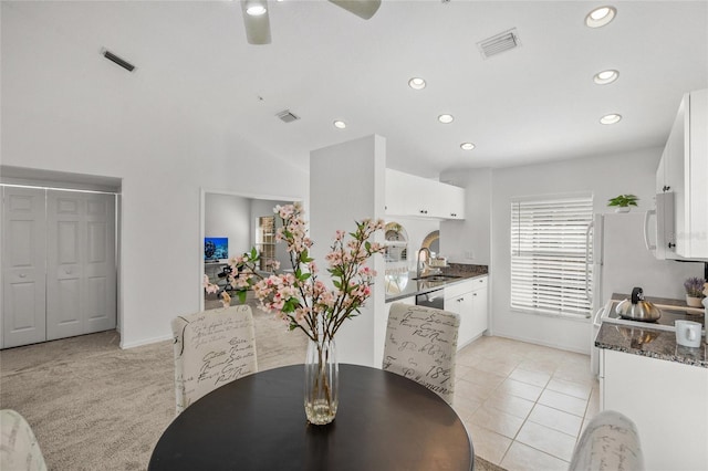 dining area featuring sink, light tile patterned floors, and ceiling fan