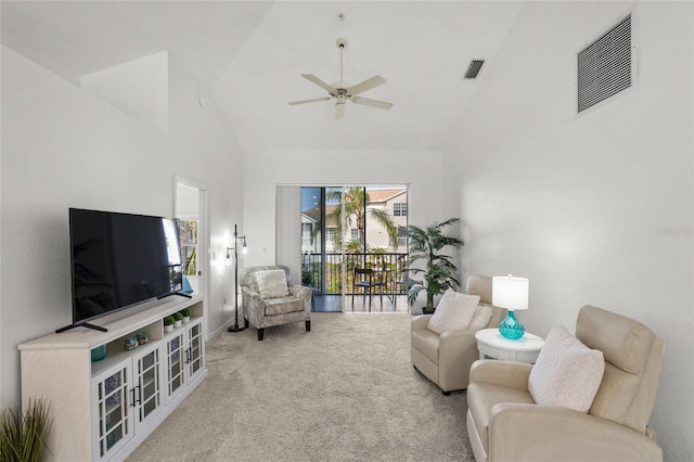 carpeted living room featuring ceiling fan and high vaulted ceiling