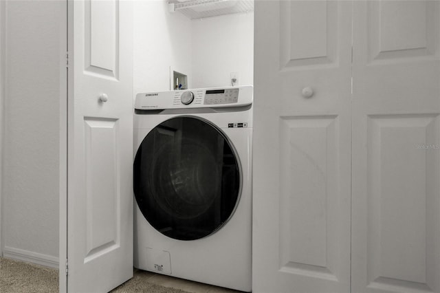 washroom with washer / clothes dryer