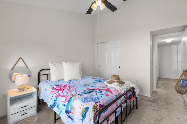 bedroom with ceiling fan, carpet flooring, and a closet