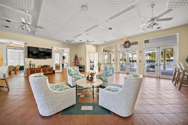 living room featuring french doors, ceiling fan, and tile patterned floors