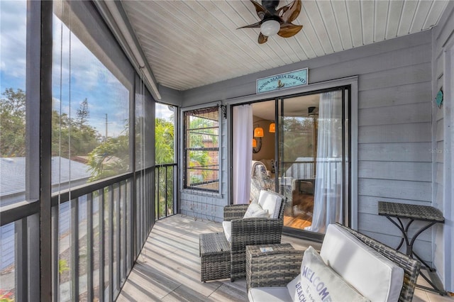 sunroom with wood ceiling and ceiling fan