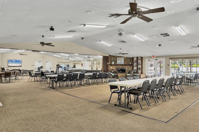 carpeted dining room featuring vaulted ceiling