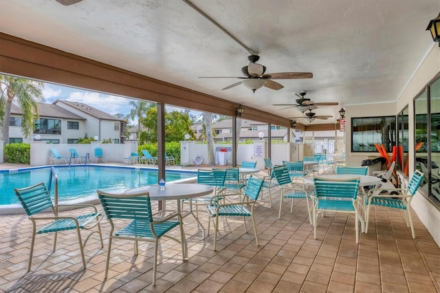 view of swimming pool with a patio area and ceiling fan