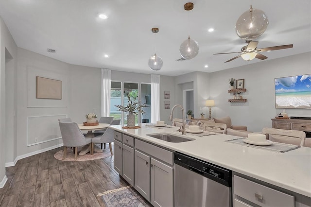 kitchen featuring sink, dishwasher, gray cabinetry, hanging light fixtures, and dark hardwood / wood-style floors