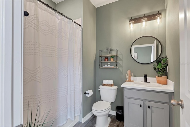 bathroom featuring vanity, hardwood / wood-style floors, and toilet