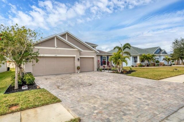 view of front of home with a garage and a front lawn