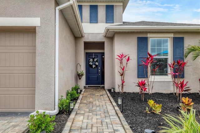 view of exterior entry featuring a garage