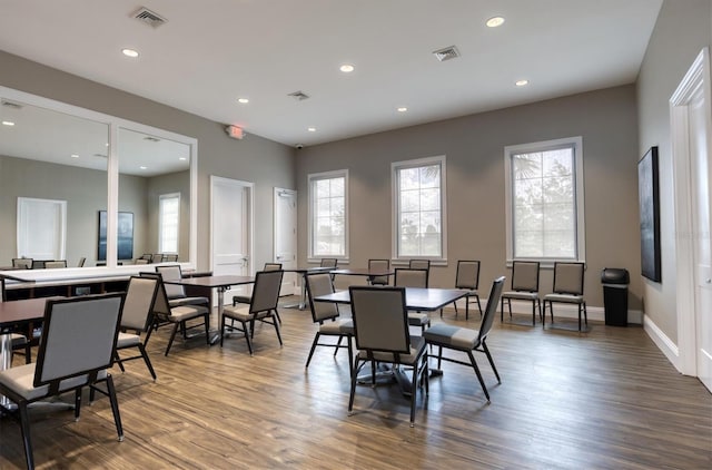 dining space with hardwood / wood-style flooring