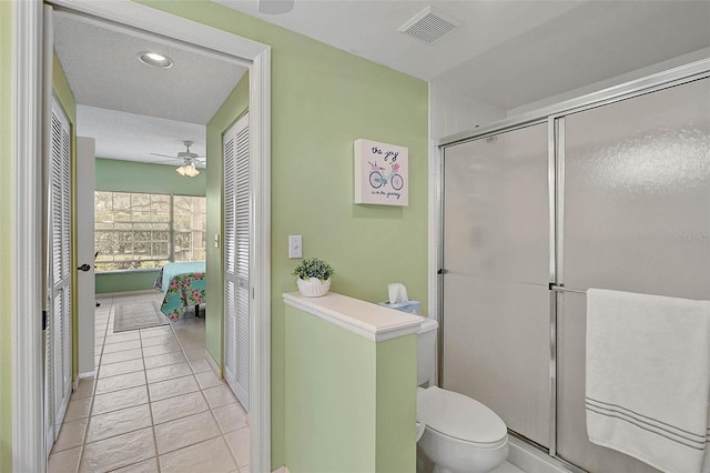 bathroom with walk in shower, ceiling fan, tile patterned floors, and toilet