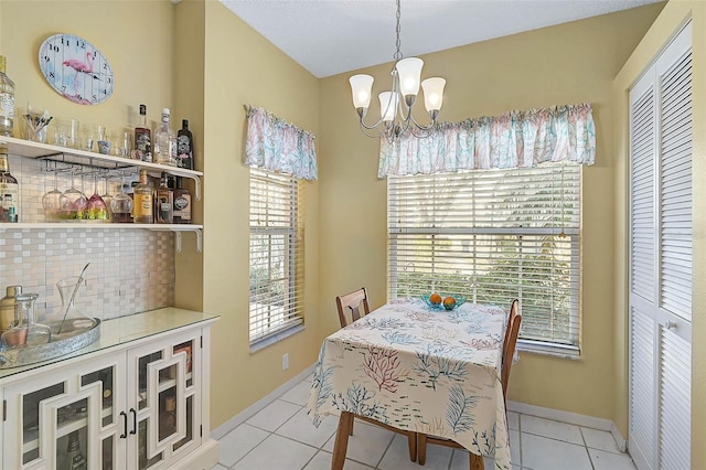 tiled dining space with a notable chandelier