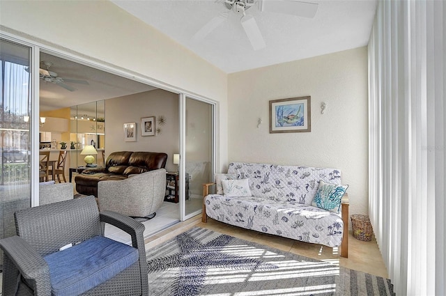 living room featuring ceiling fan and tile patterned flooring