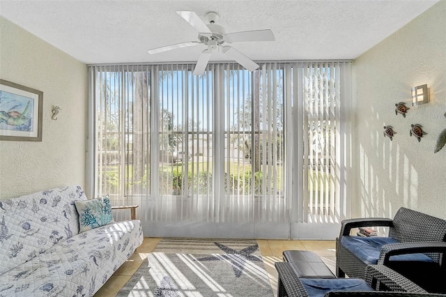 sunroom featuring ceiling fan