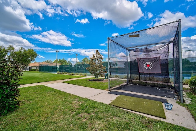 exterior space featuring a lawn and tennis court