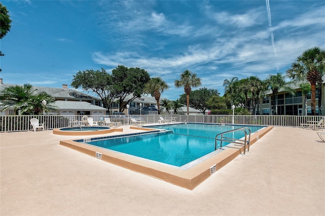 view of pool with a patio area and a community hot tub