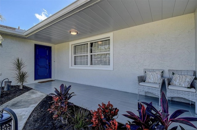 property entrance featuring stucco siding