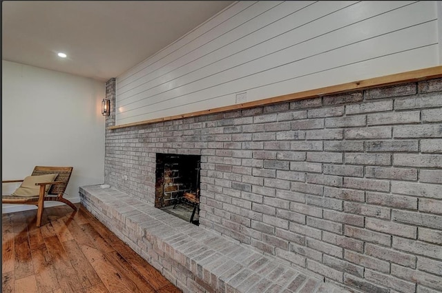 interior details featuring wood-type flooring and a fireplace