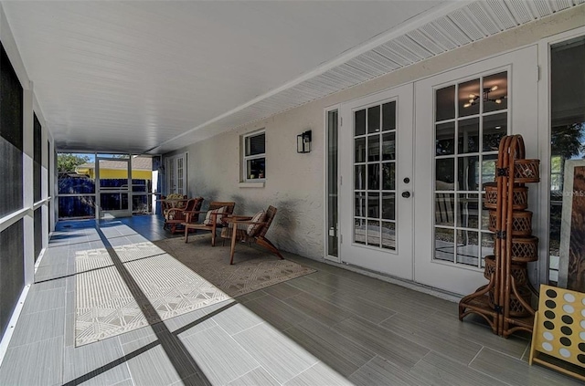 sunroom / solarium featuring french doors