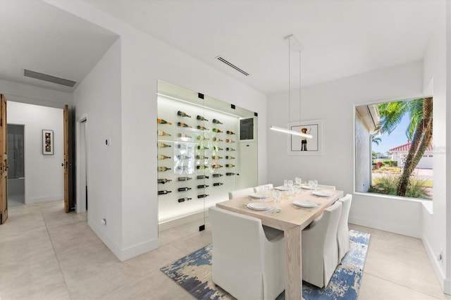 dining area with light tile patterned floors, visible vents, and baseboards