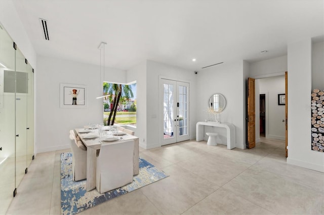 foyer entrance with visible vents, baseboards, and french doors