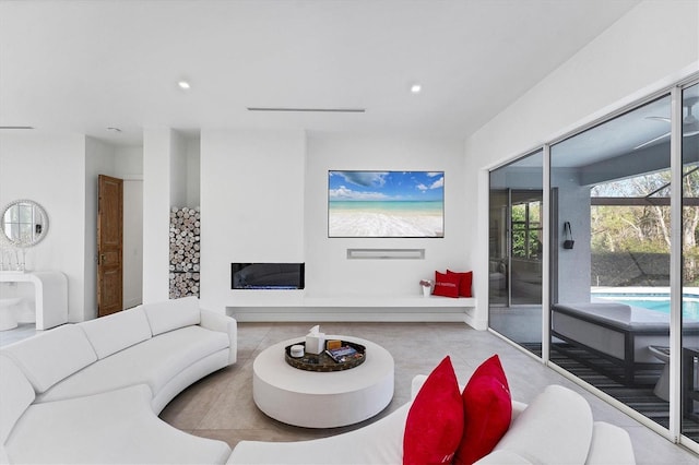 living room with a glass covered fireplace and recessed lighting