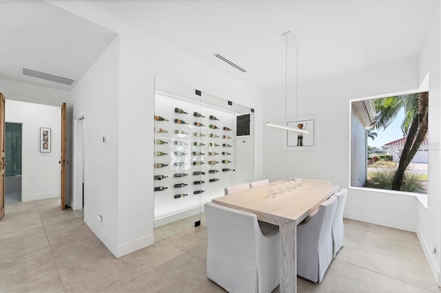 dining space with light tile patterned floors, visible vents, and baseboards