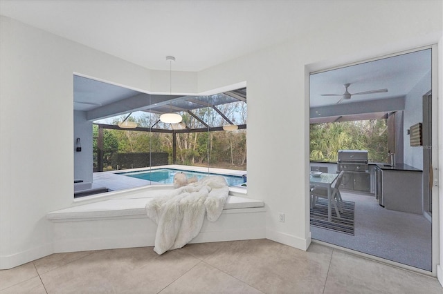 interior space featuring a ceiling fan, a sink, and grilling area