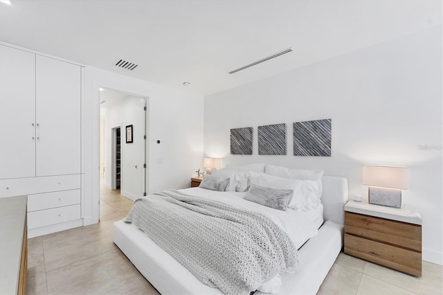 bedroom with light tile patterned flooring and visible vents