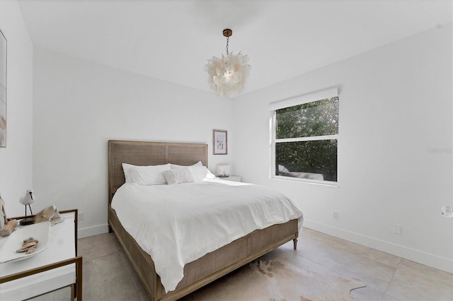 bedroom with an inviting chandelier and baseboards