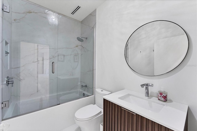 full bathroom featuring visible vents, vanity, toilet, and combined bath / shower with glass door