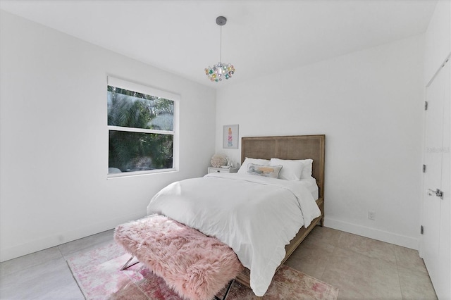 bedroom with light tile patterned flooring and baseboards