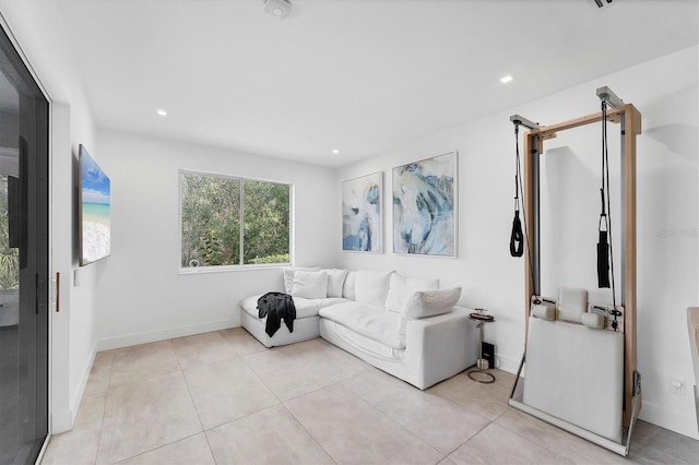 living area featuring baseboards, light tile patterned flooring, and recessed lighting