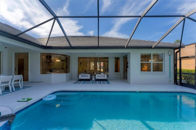 outdoor pool featuring an outdoor hangout area, glass enclosure, and a patio area