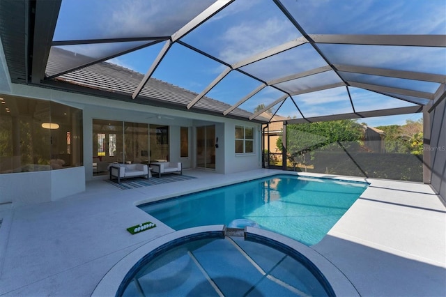 view of swimming pool with a patio area, a pool with connected hot tub, glass enclosure, and ceiling fan