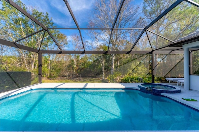 view of swimming pool with glass enclosure, a patio area, and a pool with connected hot tub