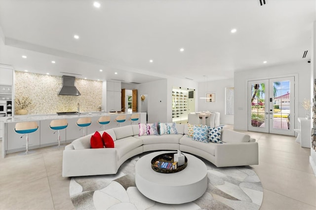 living area with light tile patterned floors, french doors, and recessed lighting