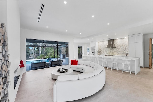 living room featuring visible vents, a sunroom, and recessed lighting