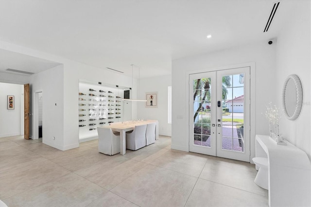 interior space with baseboards, visible vents, and french doors