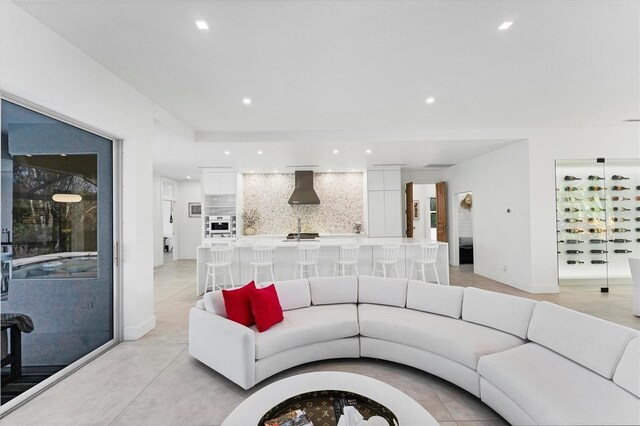 living area with baseboards and recessed lighting