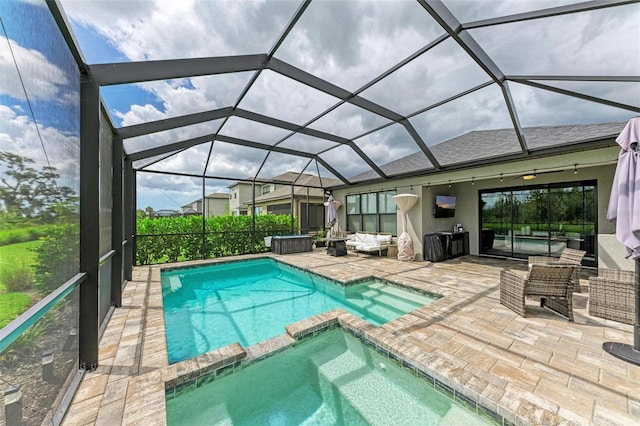 view of pool with an in ground hot tub, an outdoor hangout area, glass enclosure, and a patio area